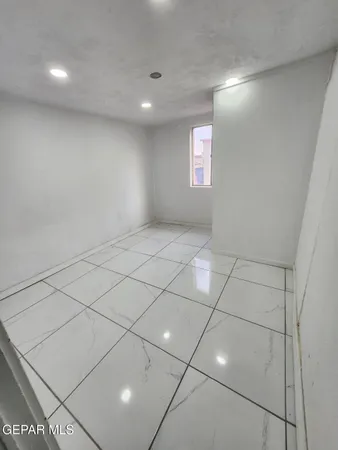 a view of an empty room and entryway in the background