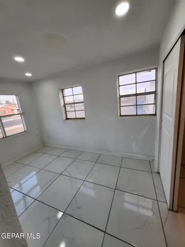 an empty room with white walls and tiles