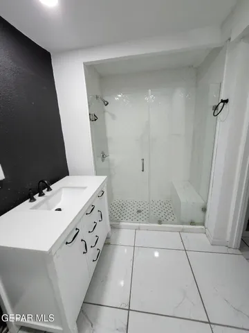 a bathroom with a sink a toilet and a shower