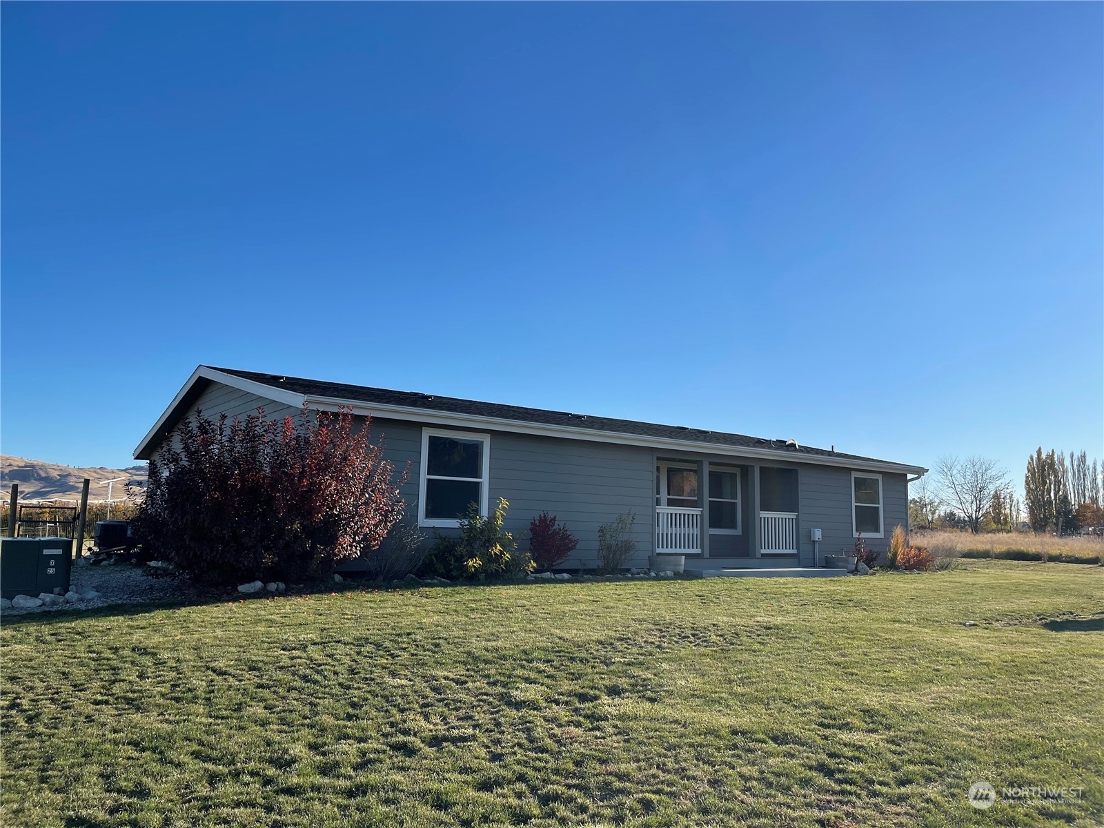 18 Root Road Okanogan, WA 98840 - Photo 2 of 36 a front view of house with yard and outdoor seating