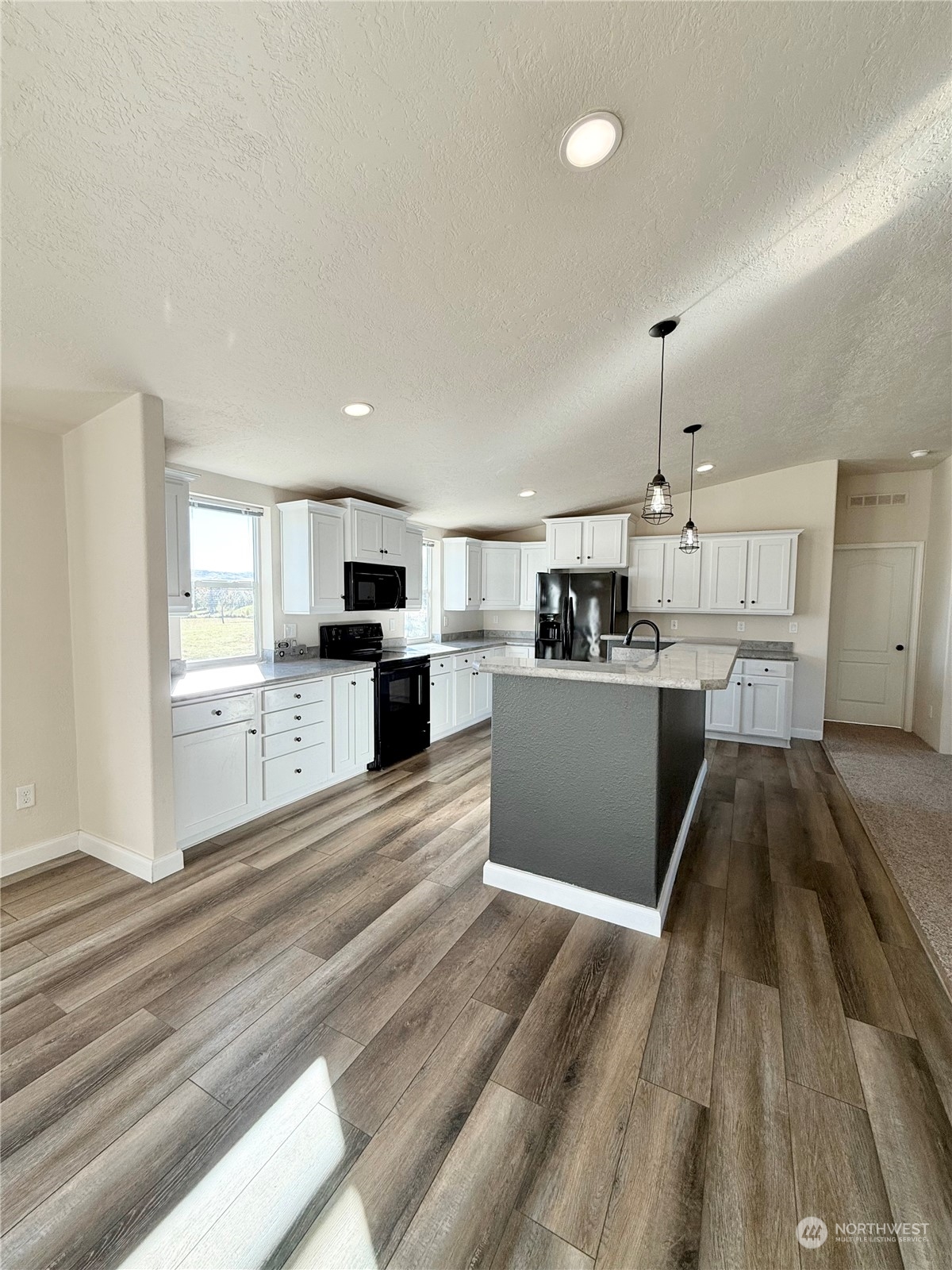 18 Root Road Okanogan, WA 98840 - Photo 10 of 36 a large kitchen with cabinets and wooden floor