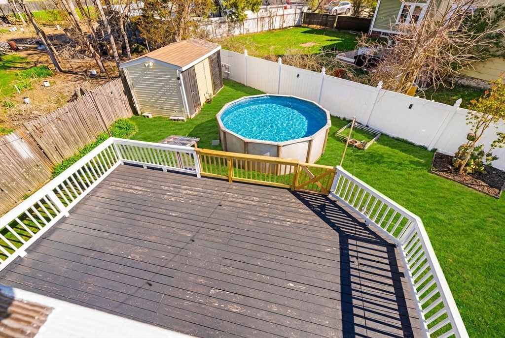 271 Broadway Haverhill, MA 01832 - Photo 32 of 41 a view of a swimming pool with two chairs next to a yard