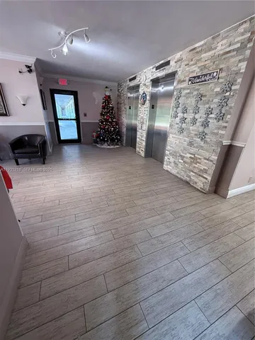 a lobby with furniture and potted plants