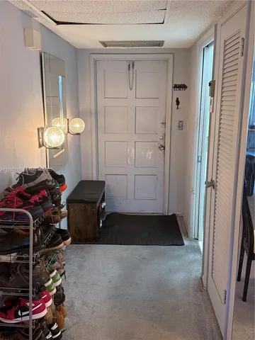 a view of a field with a tree in the background