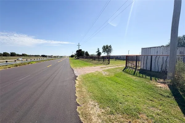 a view of balcony with wooden floor and fence