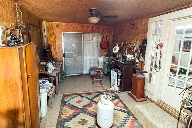 a room with furniture a flat screen tv and a window