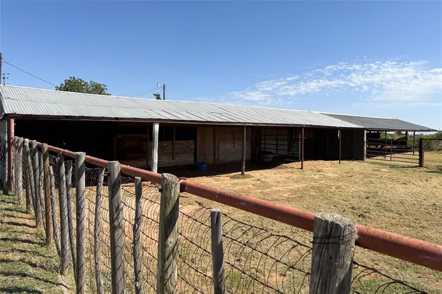 a view of a backyard with fridge and wooden floor