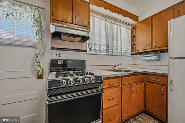 a kitchen with stainless steel appliances granite countertop cabinets and a stove top oven