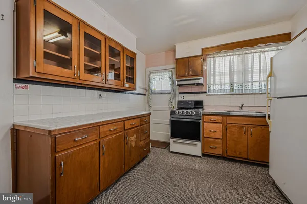a kitchen with stainless steel appliances granite countertop a stove and a refrigerator
