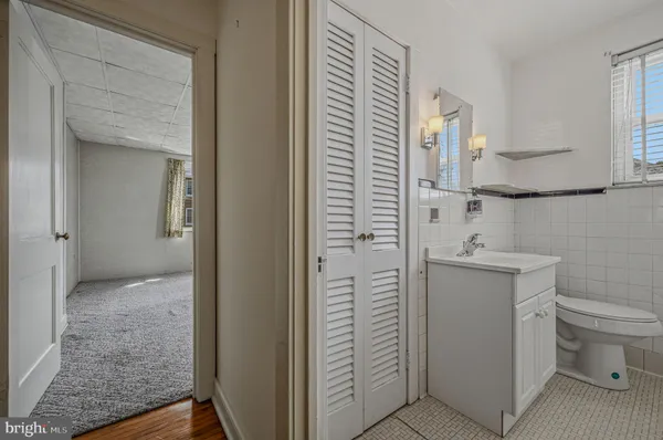 a bathroom with a granite countertop toilet and a sink