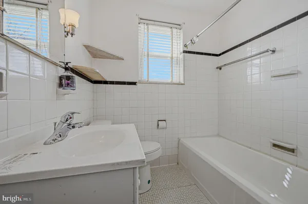 a bathroom with a sink a toilet and bathtub