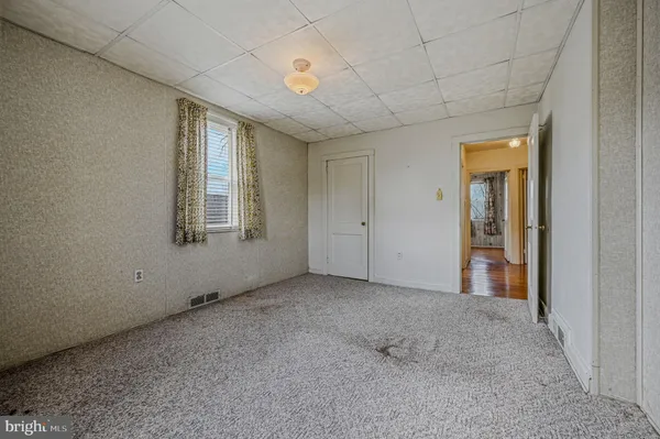 an empty room with windows and closet