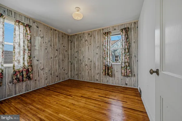 a view of a hallway with wooden floor and stairs