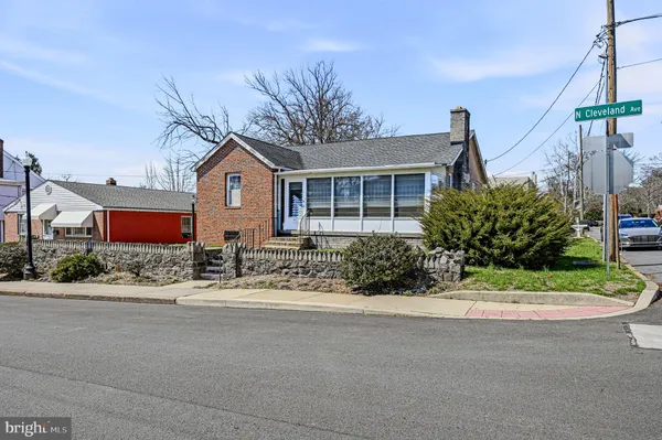 a front view of a house with a yard and potted plants