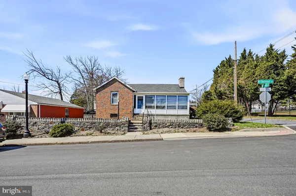 a front view of a house with a yard and trees