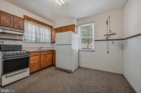 a kitchen with a stove a sink and a refrigerator