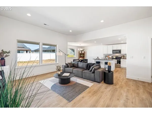 a living room with furniture and kitchen view