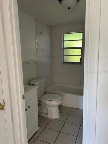 a bathroom with a toilet a sink and shower