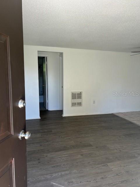 8129 Cass Road Zephyrhills, FL 33540 - Photo 5 of 6 a view of an empty room and wooden floor
