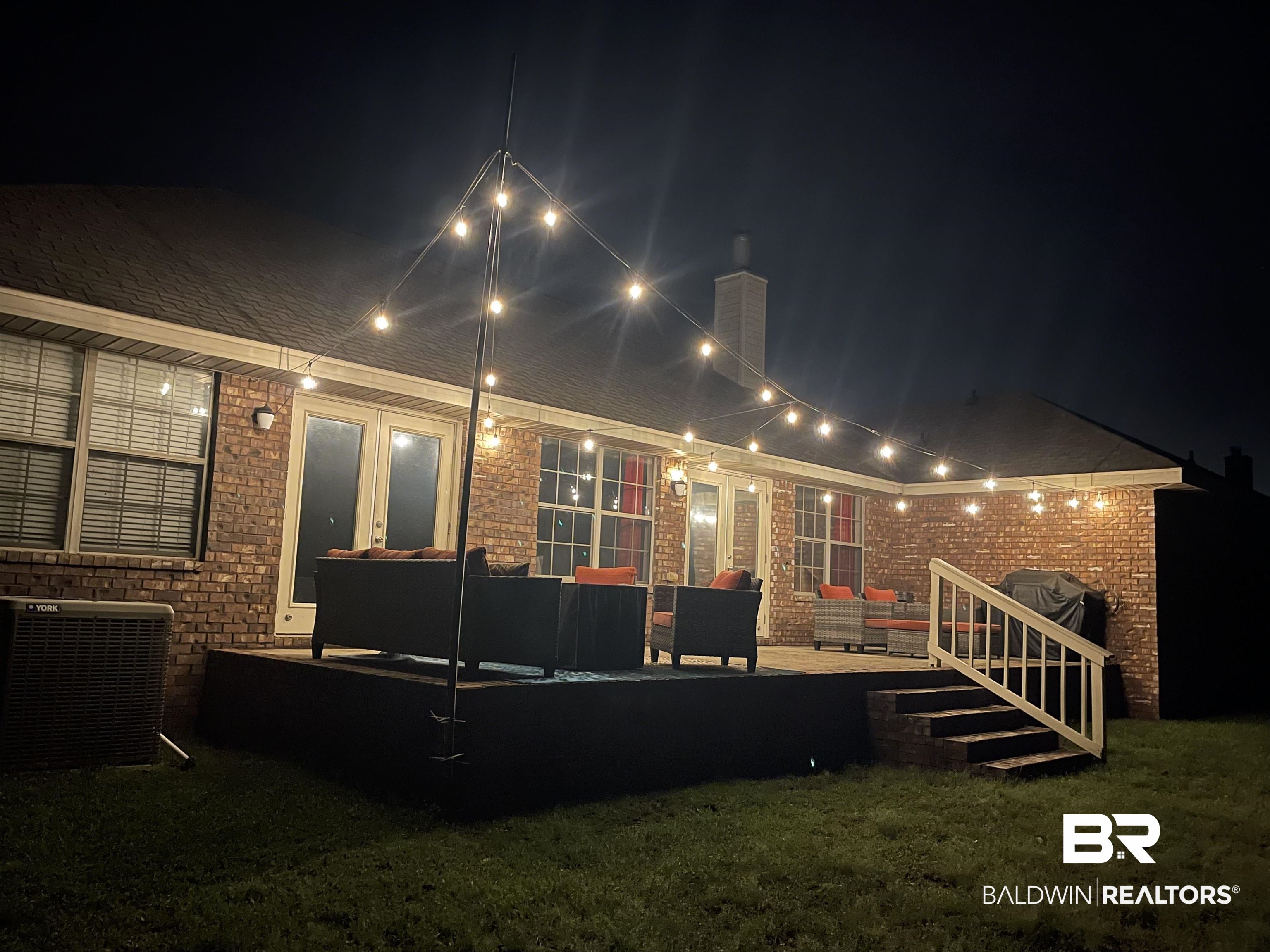 10753 Rigby Drive Mobile, AL 36695 - Photo 26 of 33 Back of house at night with cooling unit, a chimney, an outdoor hangout area, and a patio