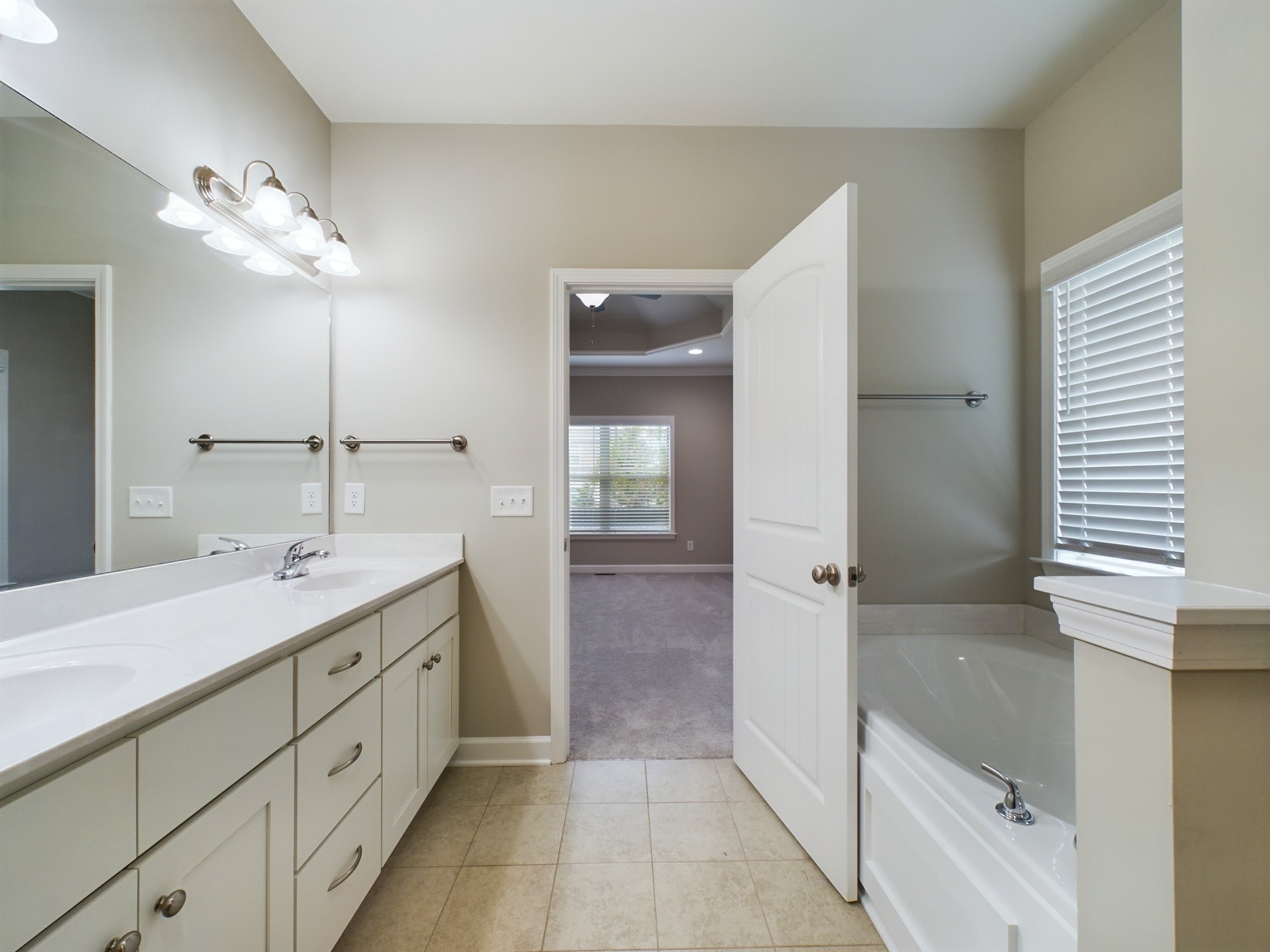 6001 Spade Drive Spring Hill, TN 37174 - Photo 19 of 31 a bathroom with a double vanity sink and a mirror
