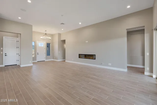a large kitchen with stainless steel appliances lots of counter space and wooden floor