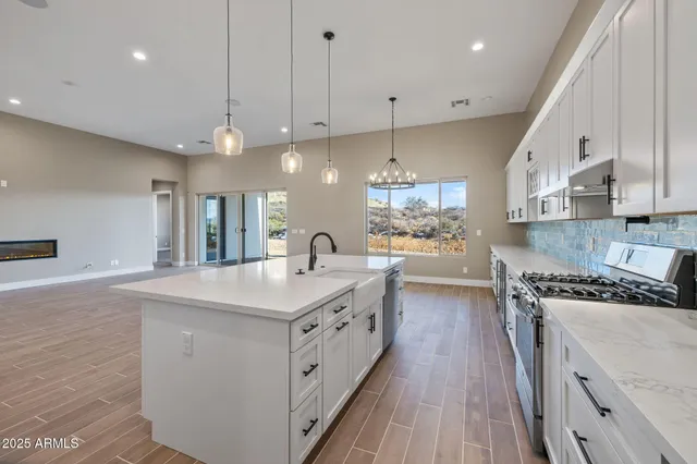 a spacious bathroom with a granite countertop sink mirror and a bathtub