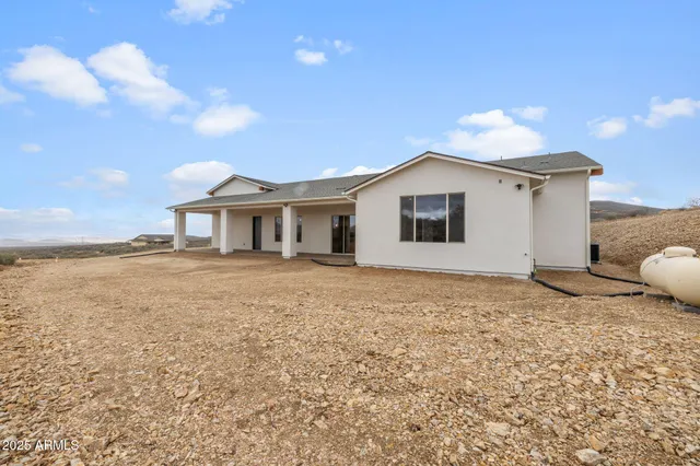a bathroom with a double vanity sink and mirror with bathtub