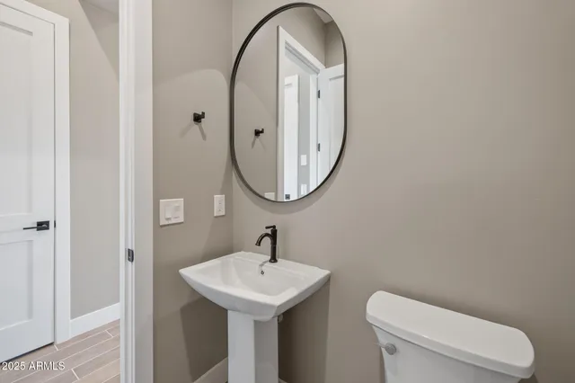 a kitchen with stainless steel appliances granite countertop a sink a stove and white cabinets