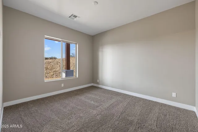 a large white kitchen with kitchen island a sink stainless steel appliances and cabinets