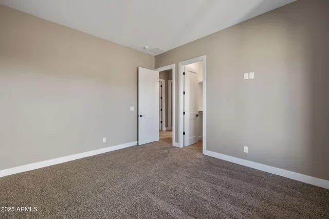 a view of a kitchen with a sink and chandelier fan