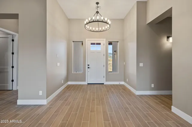 a large white kitchen with kitchen island granite countertop a stove a sink a refrigerator and white cabinets