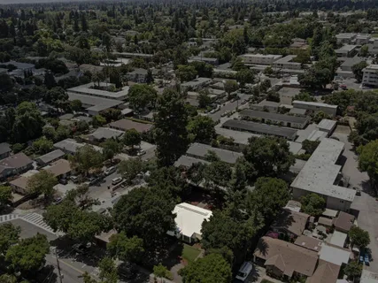 an aerial view of a house with a yard and outdoor seating