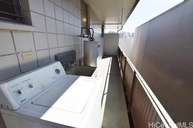 a view of storage and utility room with stairs and wooden floor