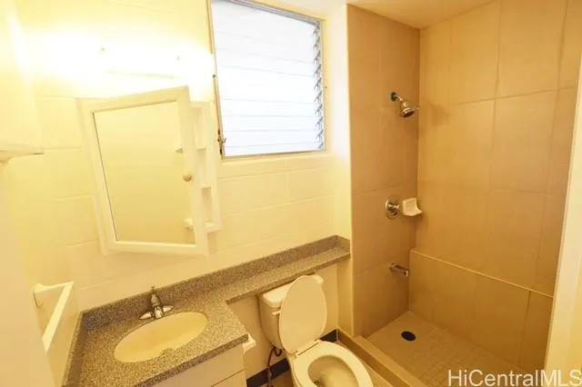 a bathroom with a shower sink and mirror