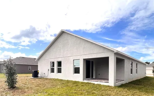 a view of a house with a backyard