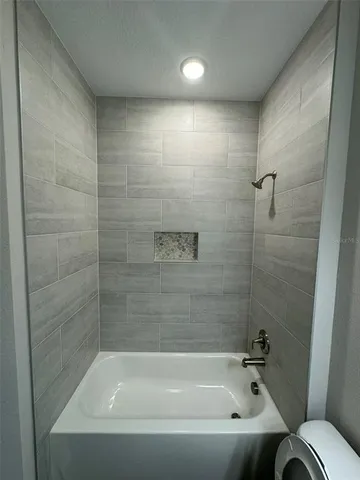 a bathroom with a bathtub and a toilet
