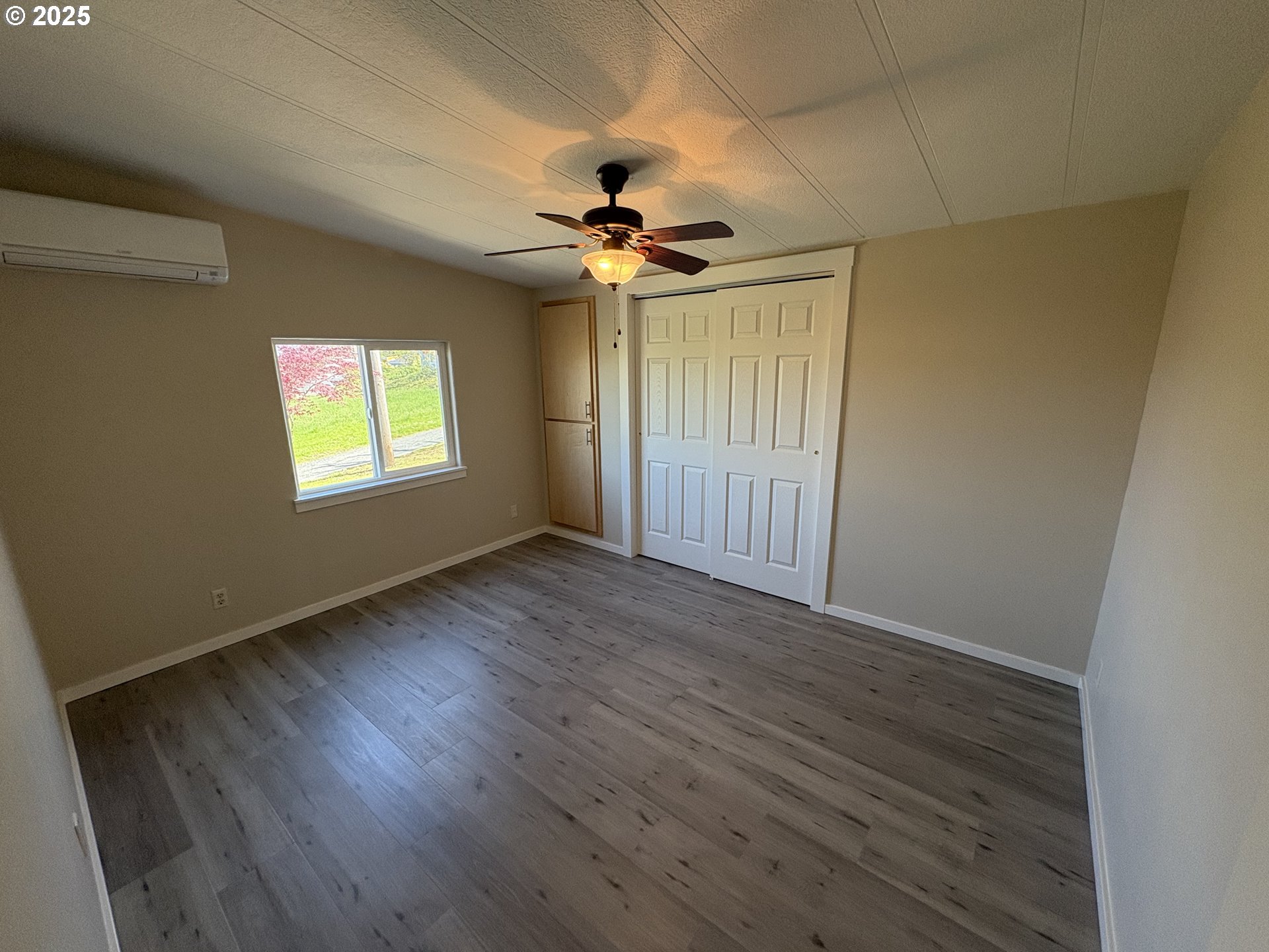 605 South 2nd Street Springfield, OR 97477 - Photo 11 of 20 an empty room with wooden floor ceiling fan and windows