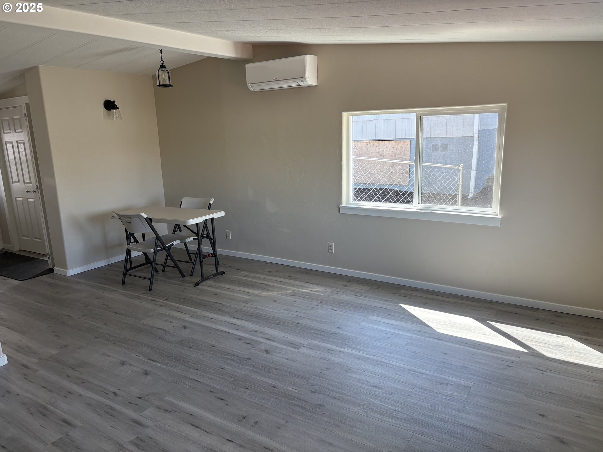 605 South 2nd Street Springfield, OR 97477 - Photo 4 of 20 an empty room with wooden floor and a window