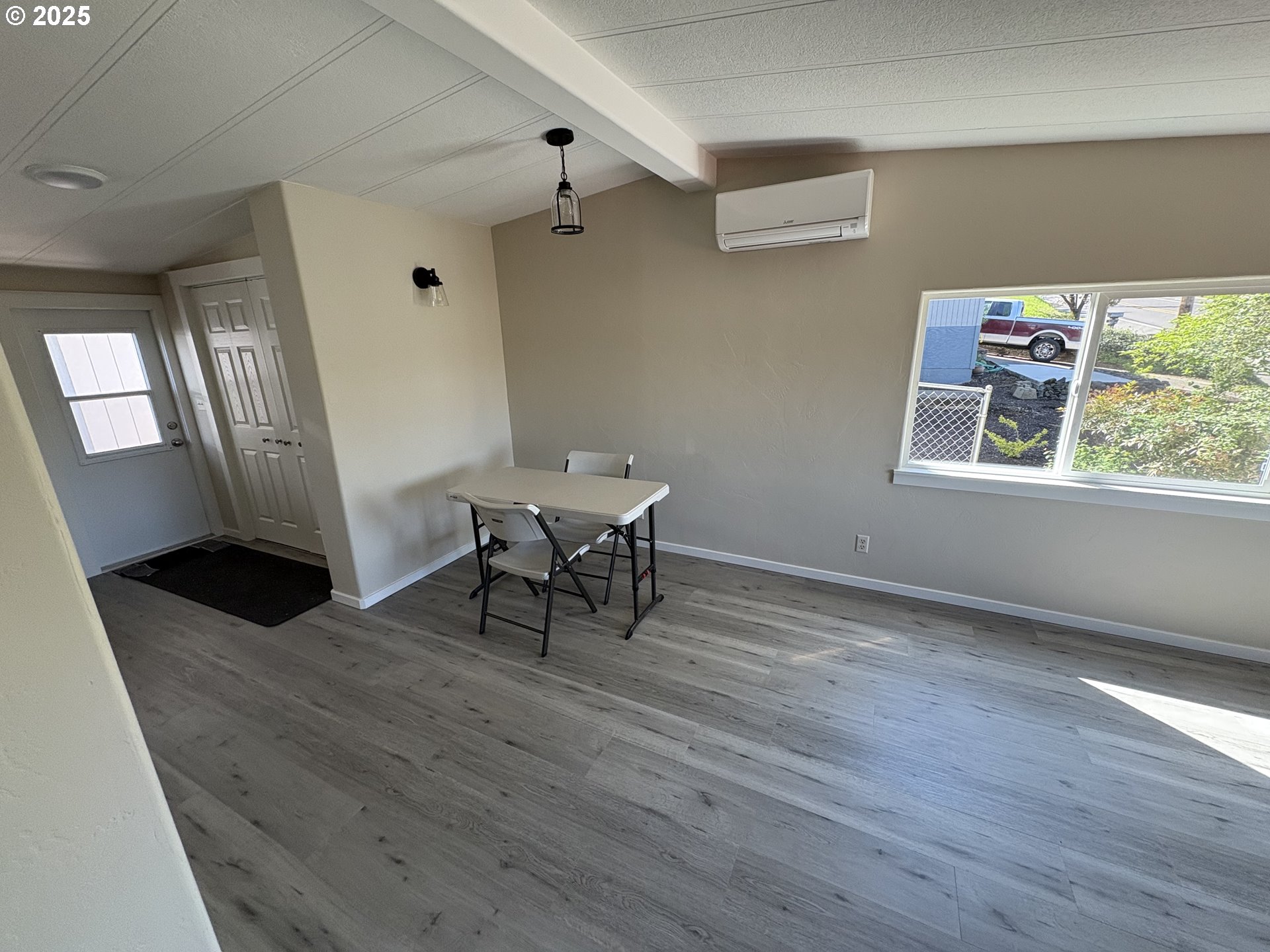 605 South 2nd Street Springfield, OR 97477 - Photo 5 of 20 a view of a room with wooden floor a ceiling fan and windows