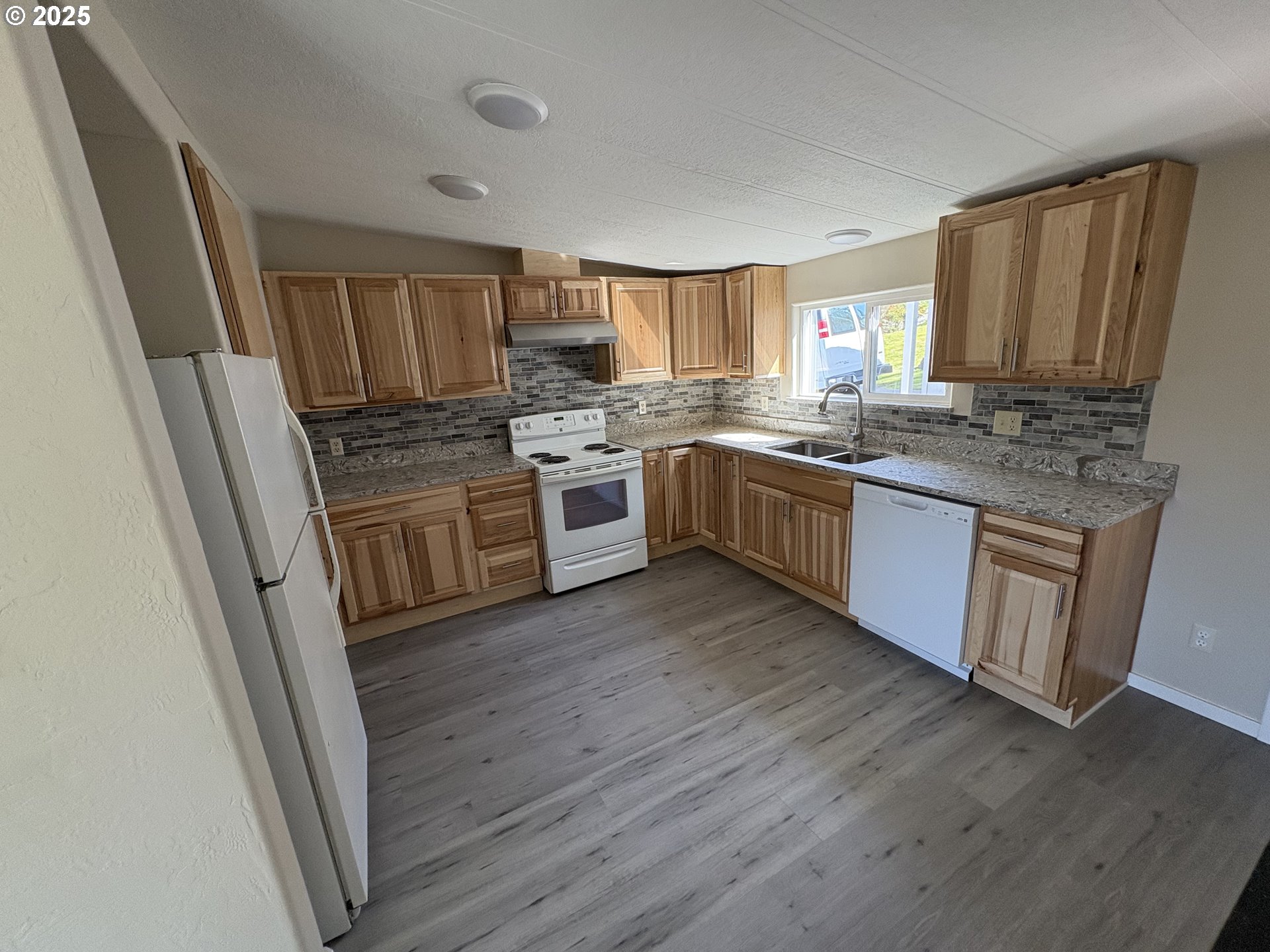 605 South 2nd Street Springfield, OR 97477 - Photo 7 of 20 a kitchen with stainless steel appliances granite countertop wooden floors and sink