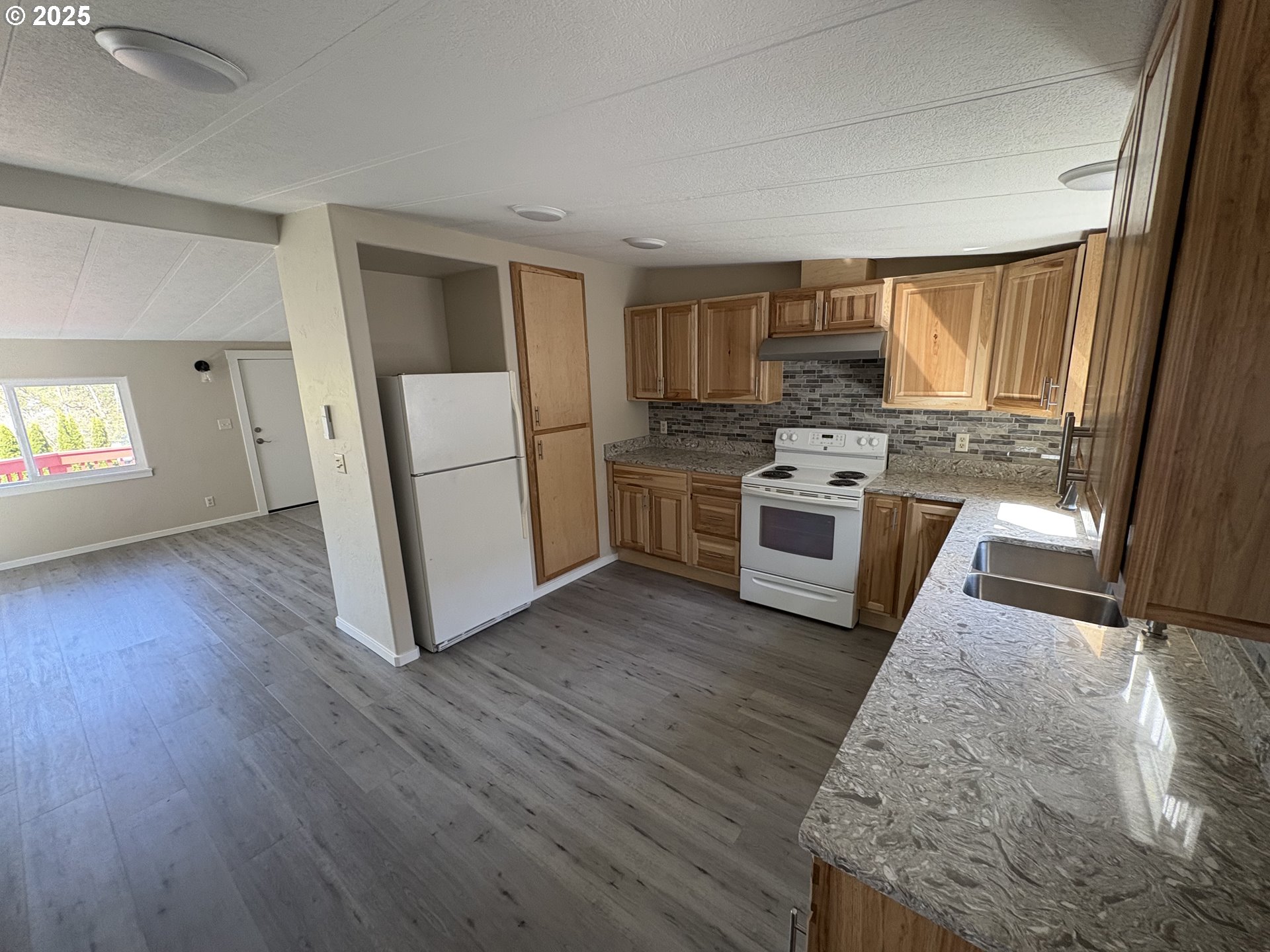 605 South 2nd Street Springfield, OR 97477 - Photo 9 of 20 a kitchen with a stove a sink and a refrigerator