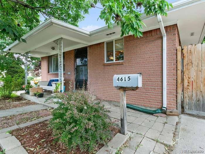 a view of a brick house with plants