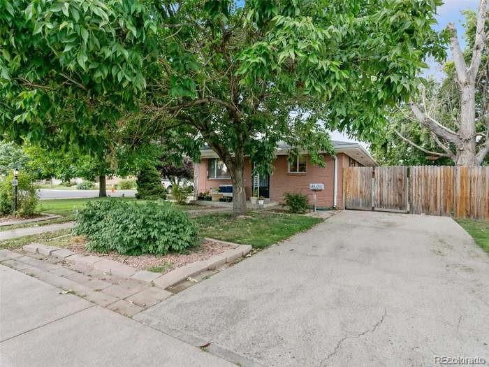 4615 Field Street Wheat Ridge, CO 80033 - Photo 3 of 13 a front view of a house with a yard and a garage