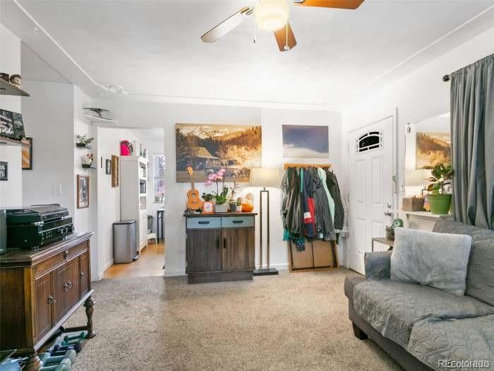 4615 Field Street Wheat Ridge, CO 80033 - Photo 6 of 13 a living room with furniture and a flat screen tv