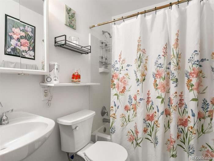 4615 Field Street Wheat Ridge, CO 80033 - Photo 7 of 13 a white toilet sitting next to a bathroom sink