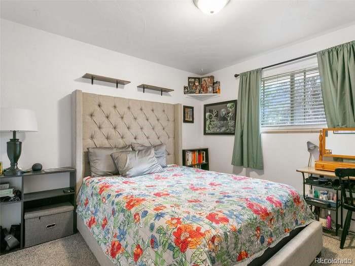 4615 Field Street Wheat Ridge, CO 80033 - Photo 8 of 13 a bedroom with a bed and a table in it