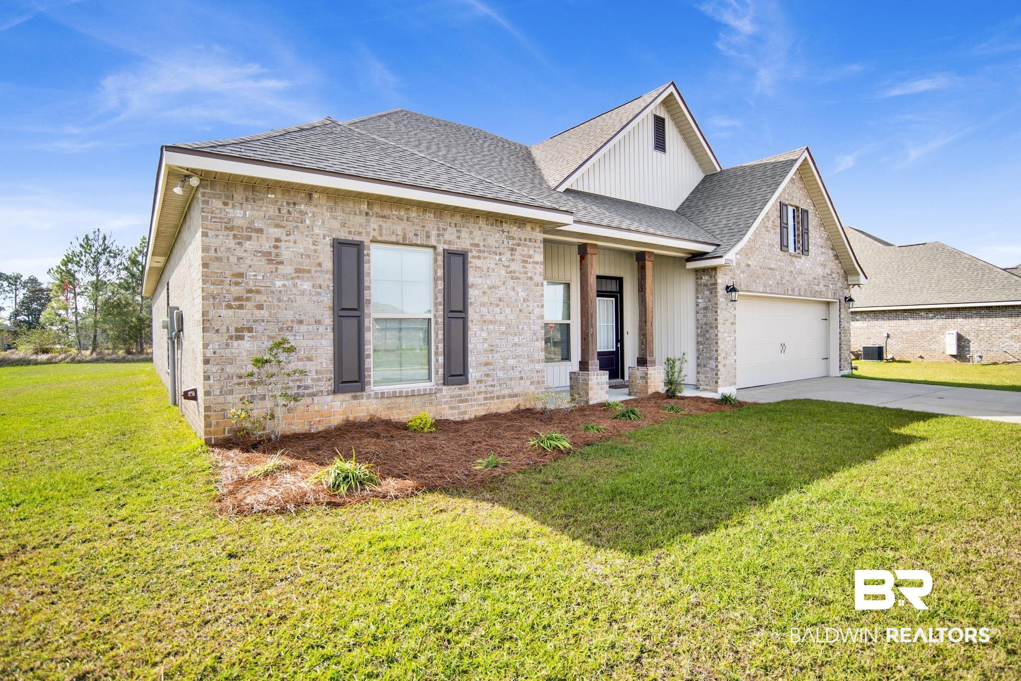 22258 Hibiscus Circle Foley, AL 36535 - Photo 2 of 26 View of front facade featuring a front lawn, driveway, roof with shingles, a garage, and brick siding