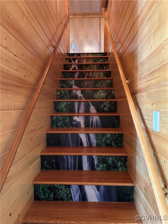 860 Allens Lake Road Dillwyn, VA 23936 - Photo 40 of 47 Stairs featuring wood walls, vaulted ceiling, and