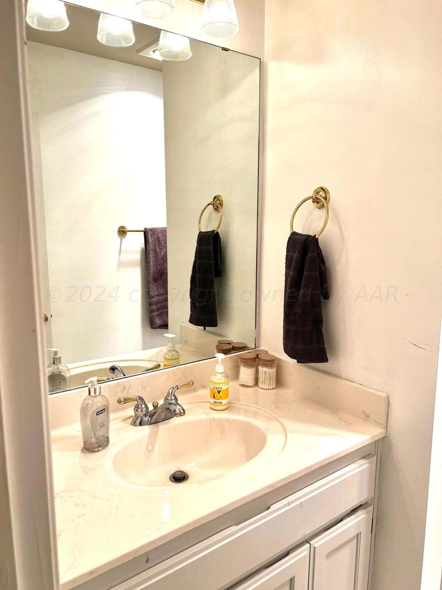 5801 South Bowie Street Amarillo, TX 79118 - Photo 11 of 23 a bathroom with a sink and a mirror